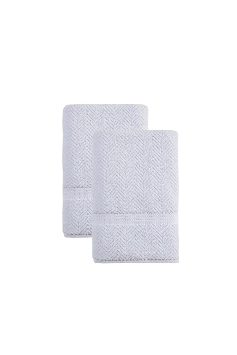 White chevron bath towels, neatly folded stack with stitched border
