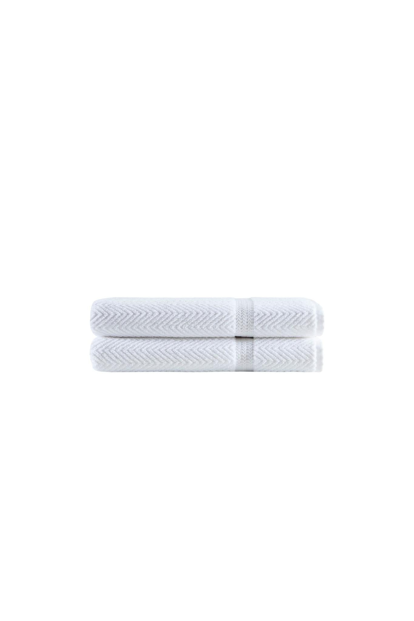 White chevron bath towels, rolled stacks tied with matching band