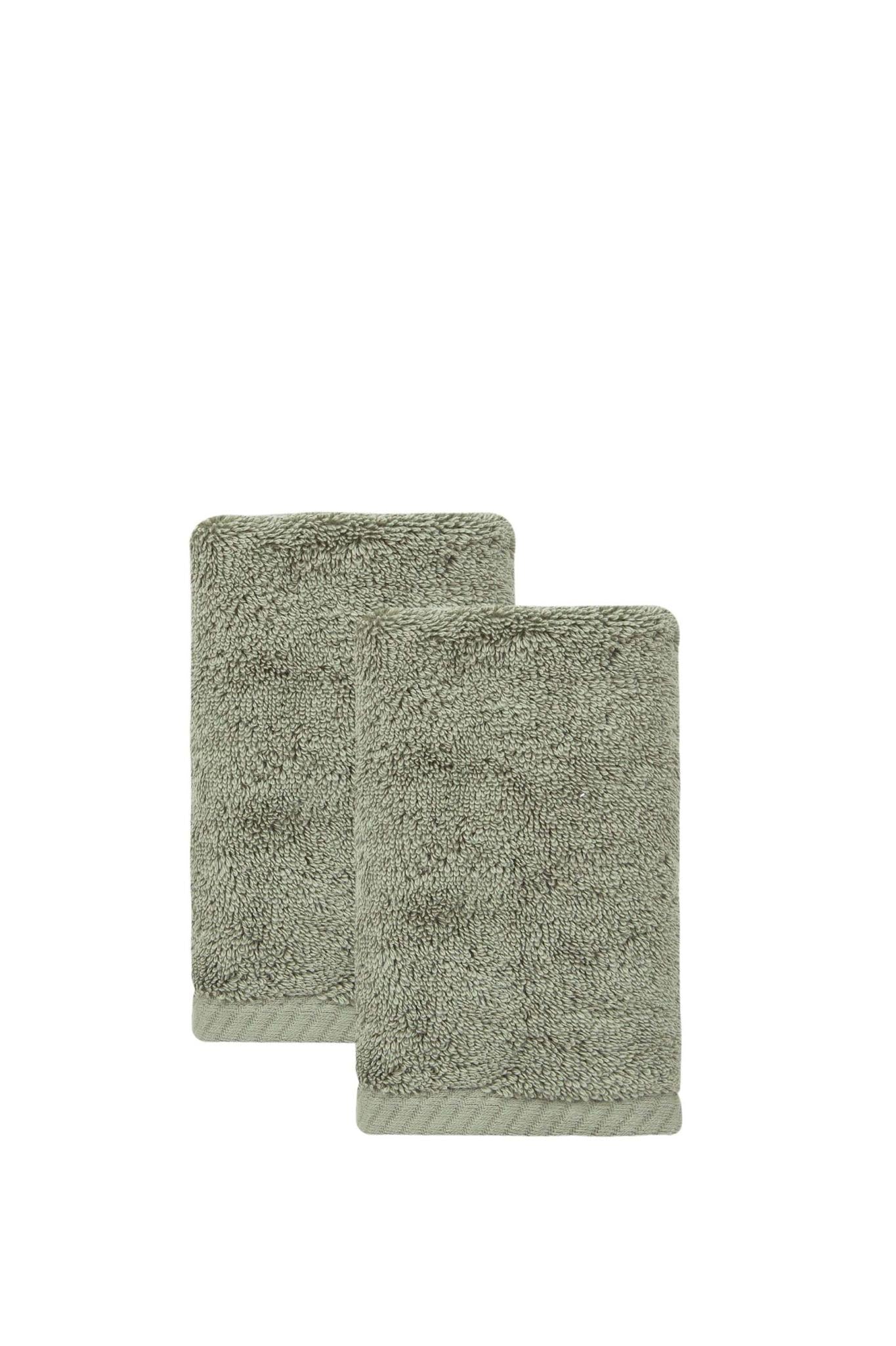 Set of two green Turkish cotton hand towels, folded terry loop pile