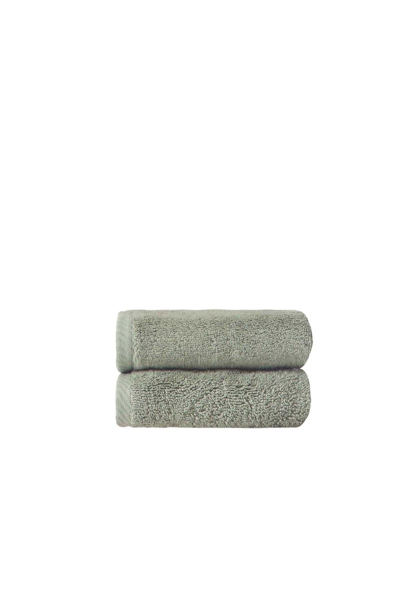 Set of two green Turkish cotton hand towels, stacked folded terry loop pile