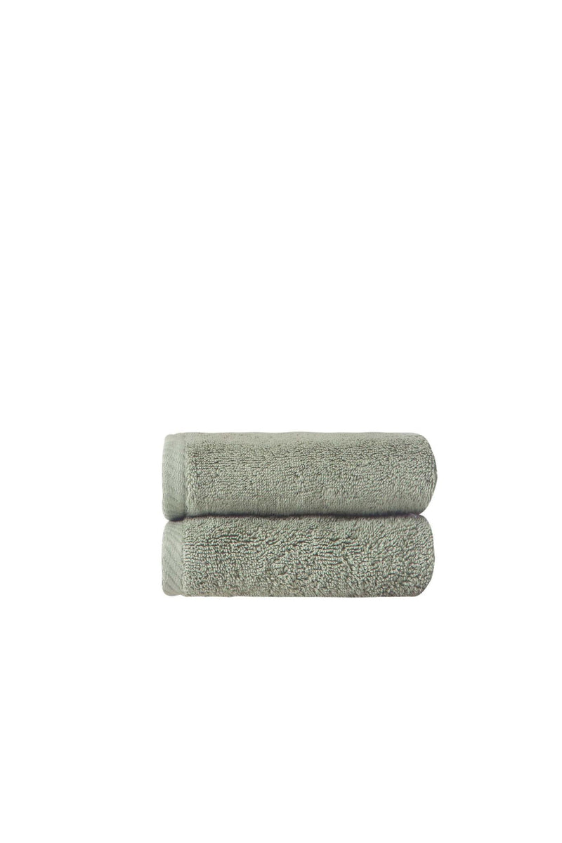 Set of two green Turkish cotton hand towels, stacked folded terry loop pile