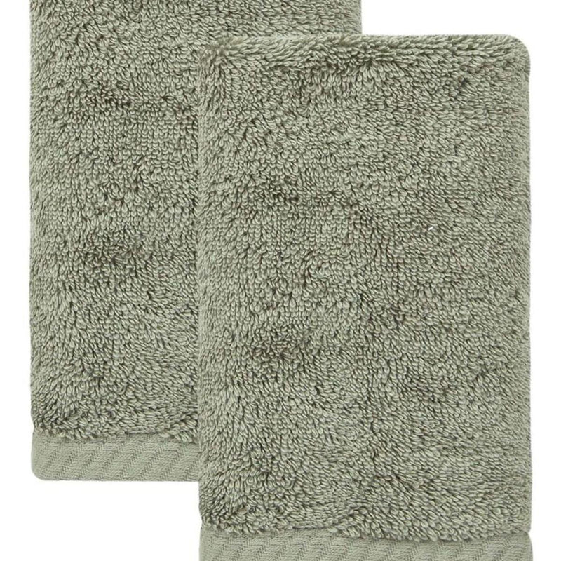 Set of two green Turkish cotton hand towels, close-up terry loop pile texture