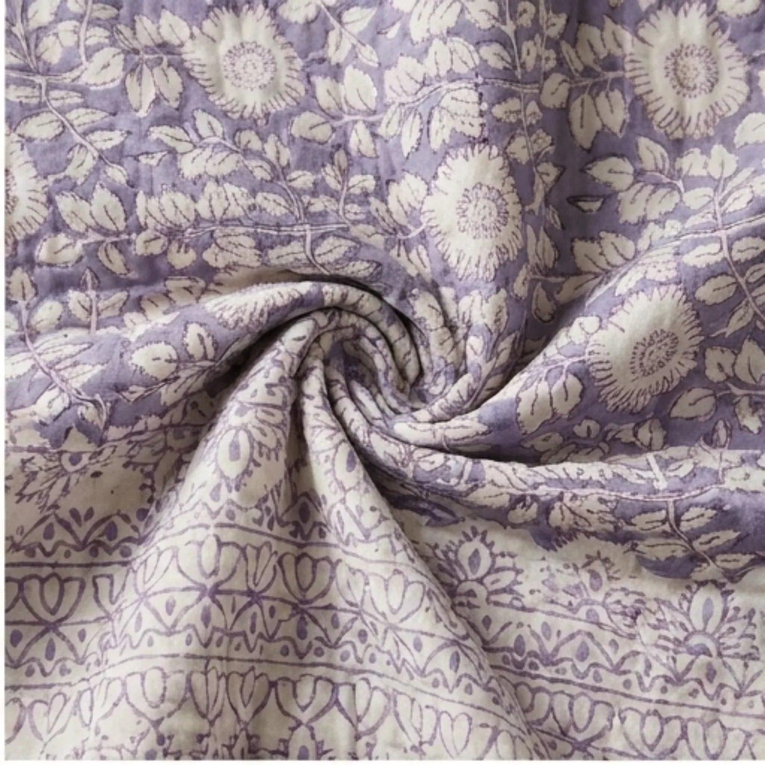 Lavender floral cotton comforter fabric with folded quilted seam detail