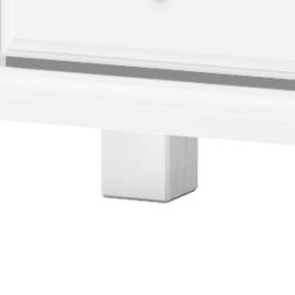 White wooden dresser corner with tapered legs and skirt panel detail