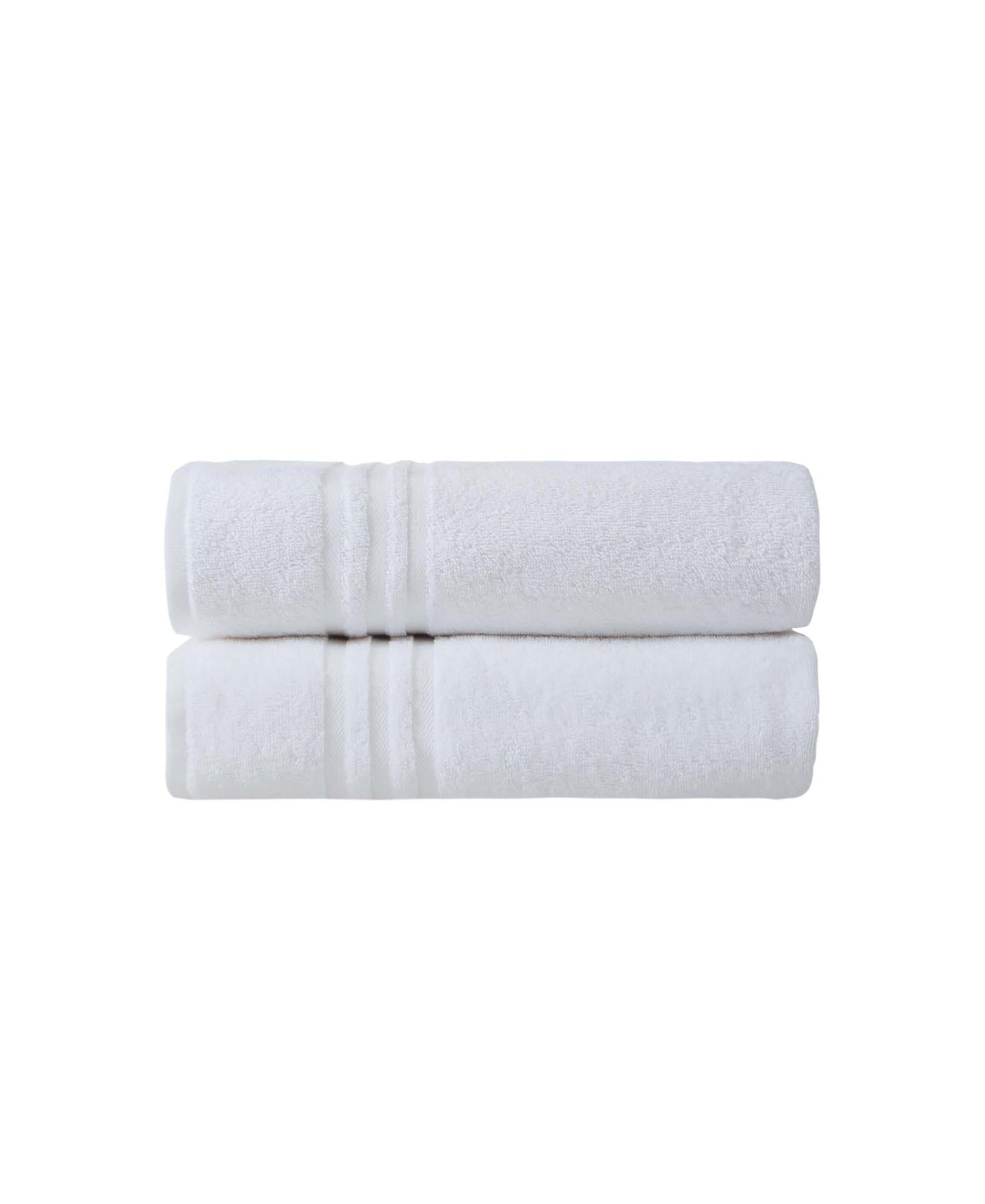 Set of two white Turkish cotton bath towels, neatly folded and stacked