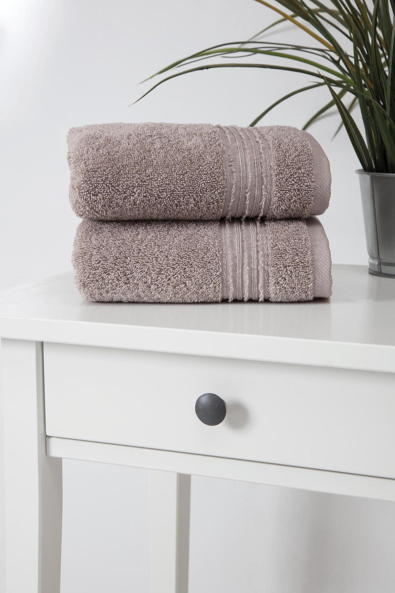 Stacked light brown Turkish hand towels with striped bands, terry texture