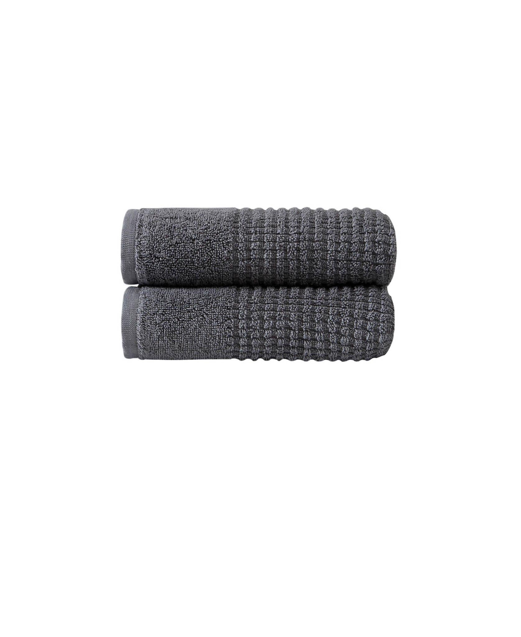 Two dark gray Turkish cotton hand towels, folded with textured polka dot weave