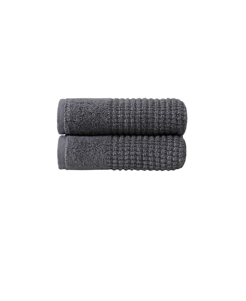 Two dark gray Turkish cotton hand towels, folded with textured polka dot weave