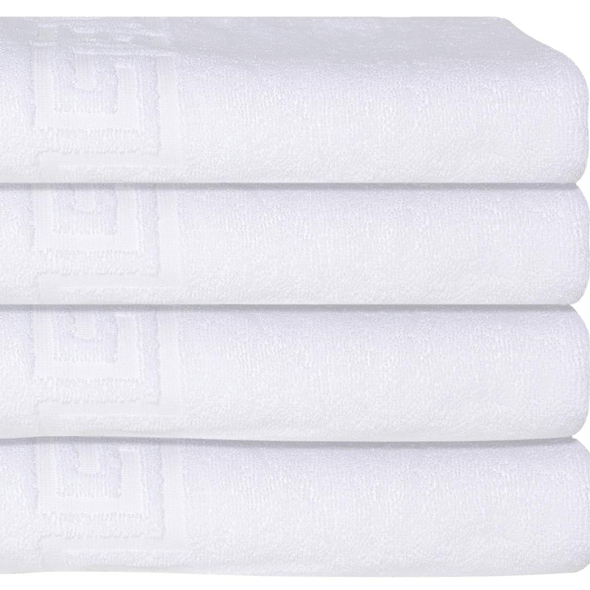 White Turkish cotton bath towel with embossed Greek key design, close-up