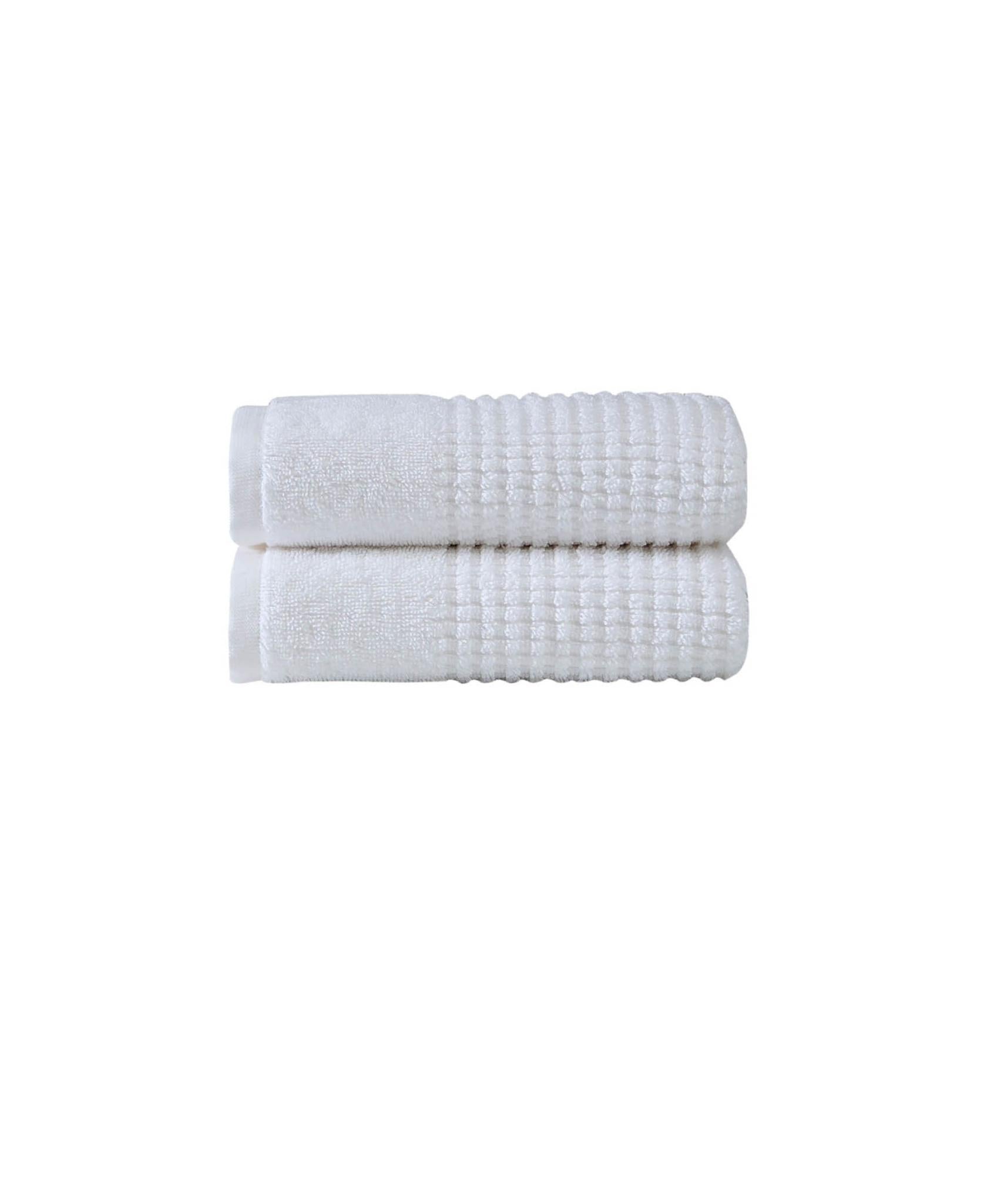 Set of two white Turkish cotton hand towels, ribbed waffle texture, folded pair