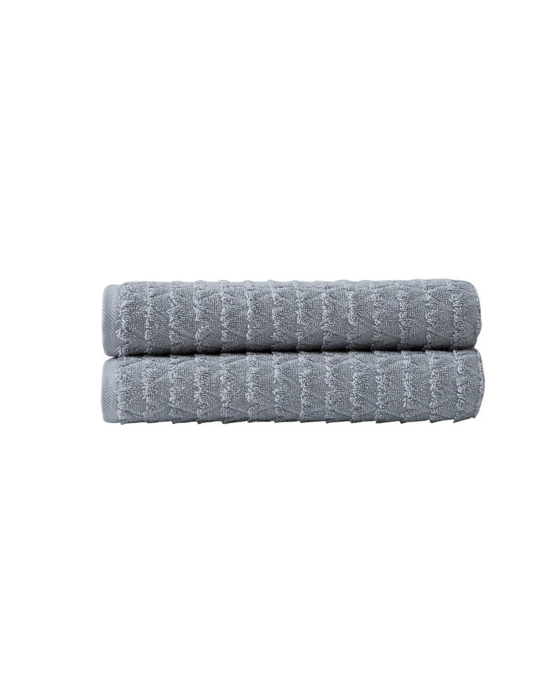 Set of two light gray bath towels with geometric pattern, neatly stacked