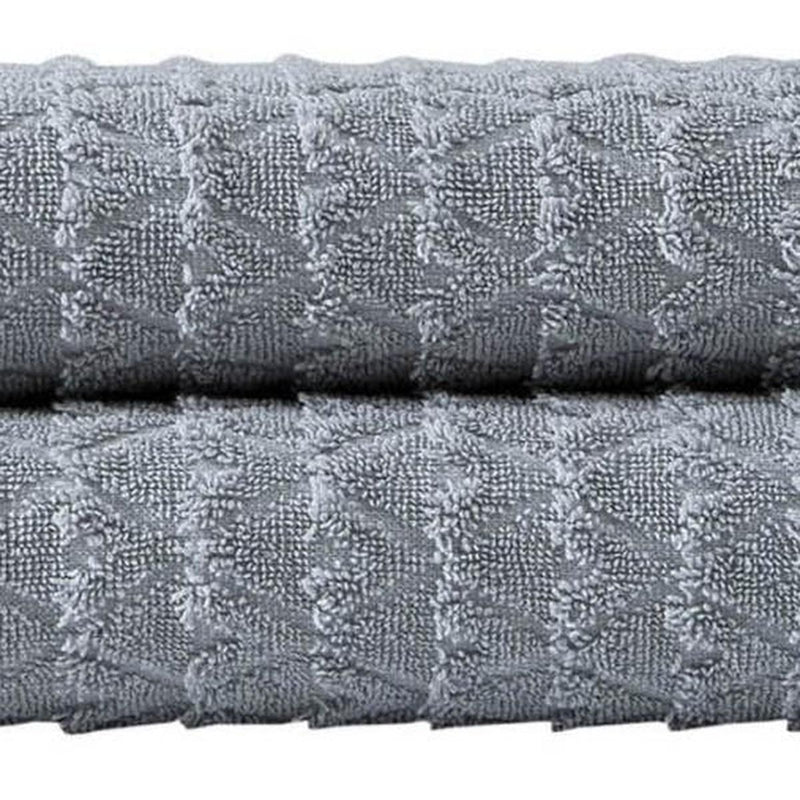 Light gray bath towel fabric with raised geometric pattern, cotton terry texture