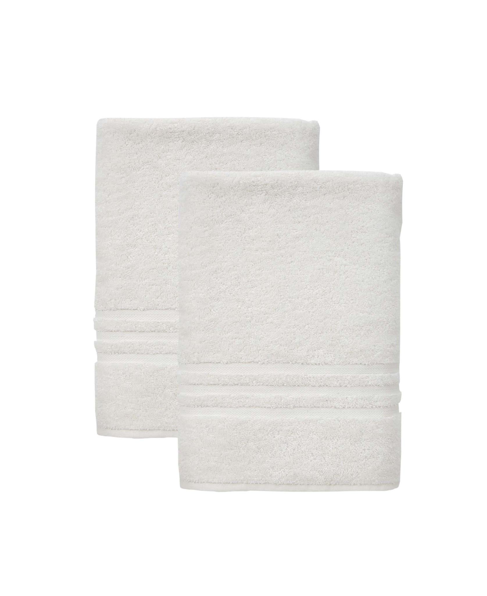 Set of two off-white bath towels, neatly folded, textured terry loop surface