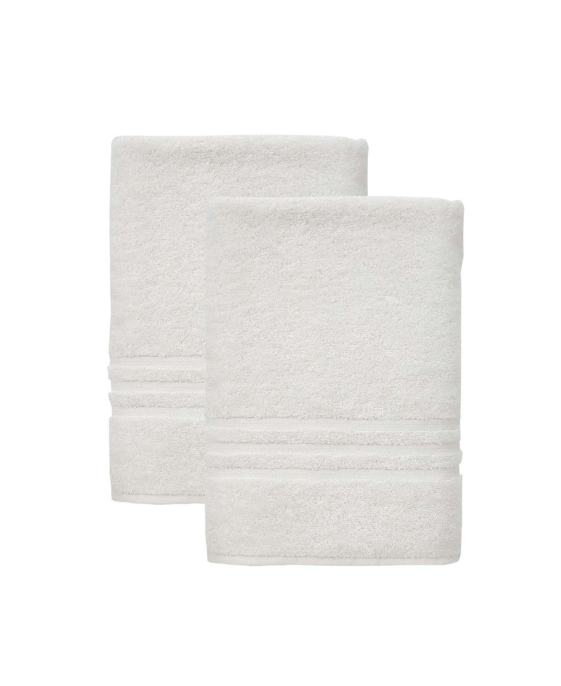 Set of two off-white bath towels, neatly folded, textured terry loop surface