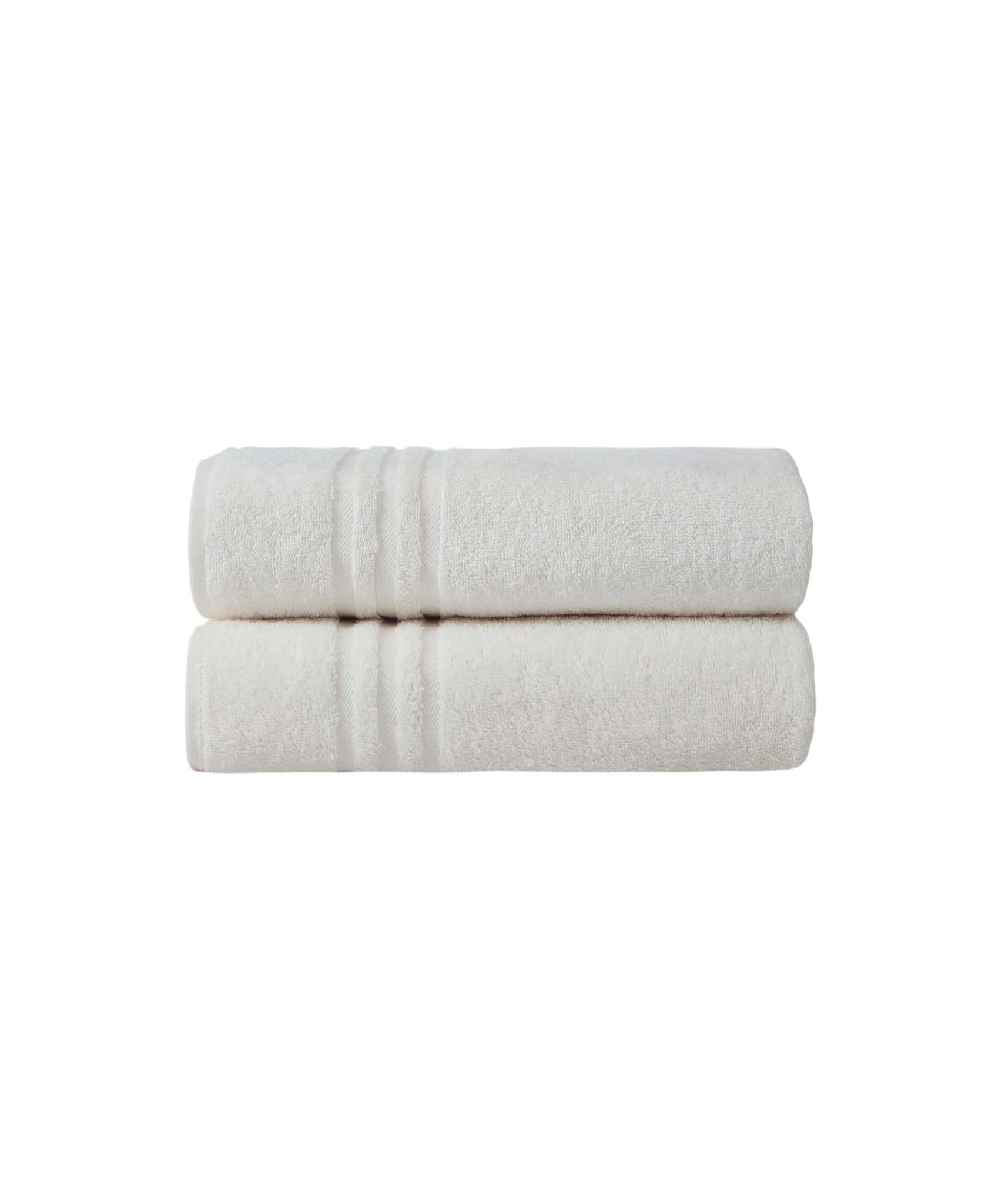 Set of two off-white bath towels, stacked and rolled, textured terry surface