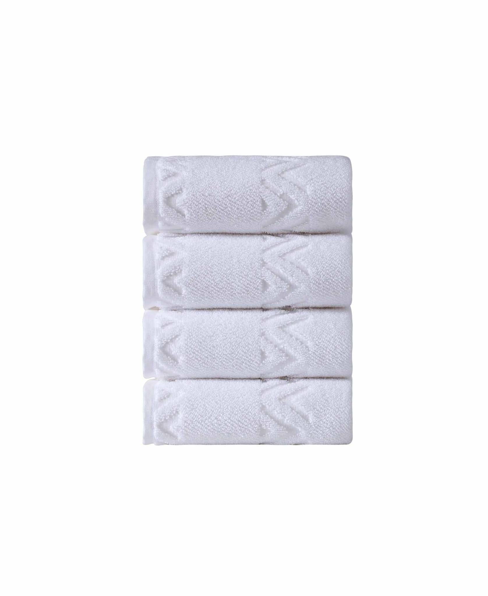 Set of four white Turkish hand towels with geometric diamond pattern, folded stack