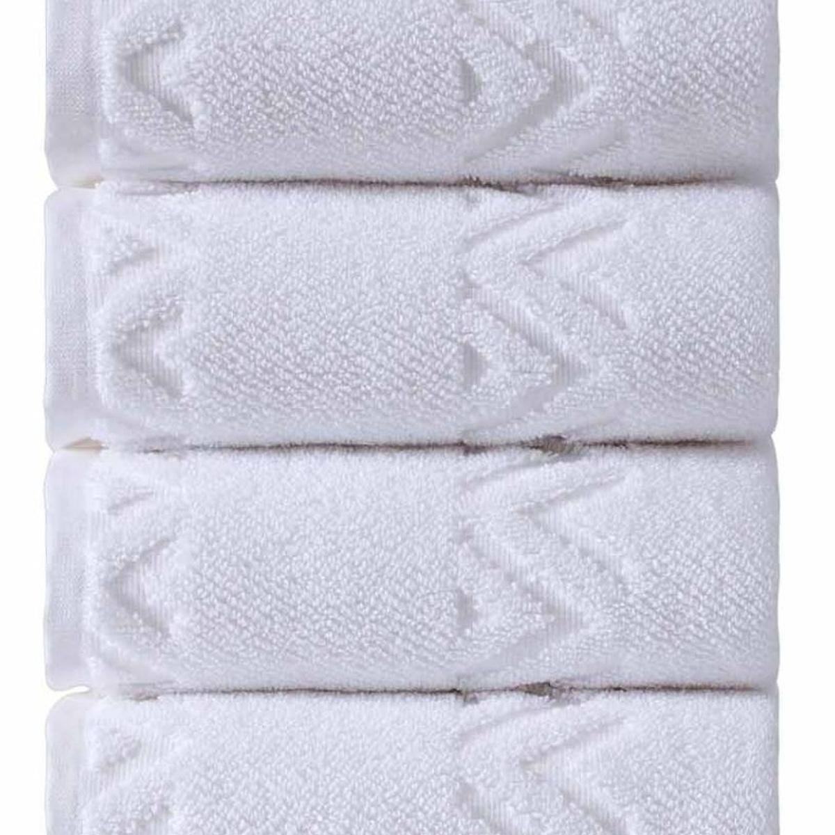 Folded white Turkish hand towels with geometric diamond pattern, close-up