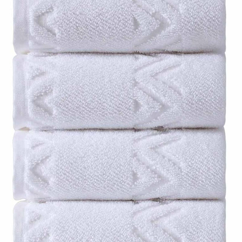 Folded white Turkish hand towels with geometric diamond pattern, close-up