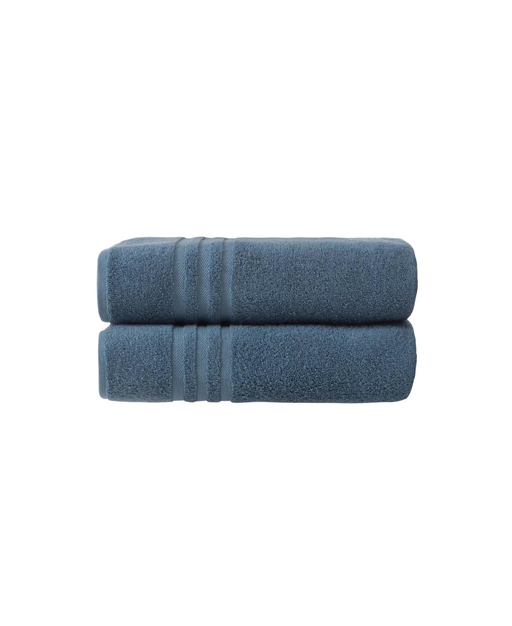 Two aqua blue bath towels rolled together, plush terry with striped accents