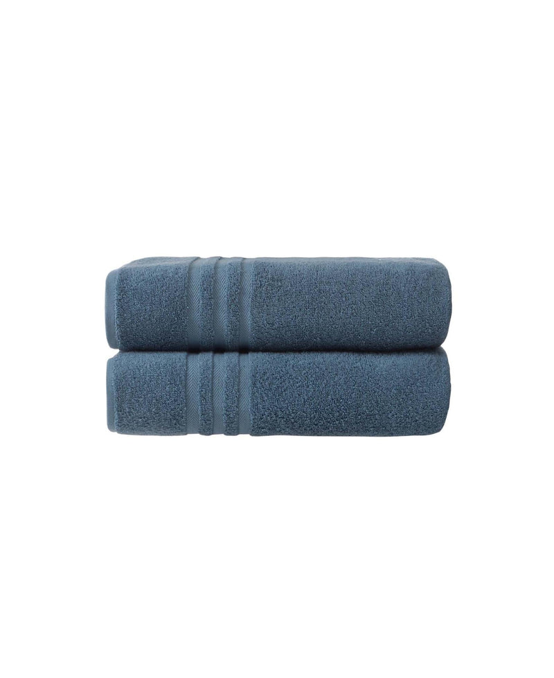Two aqua blue bath towels rolled together, plush terry with striped accents