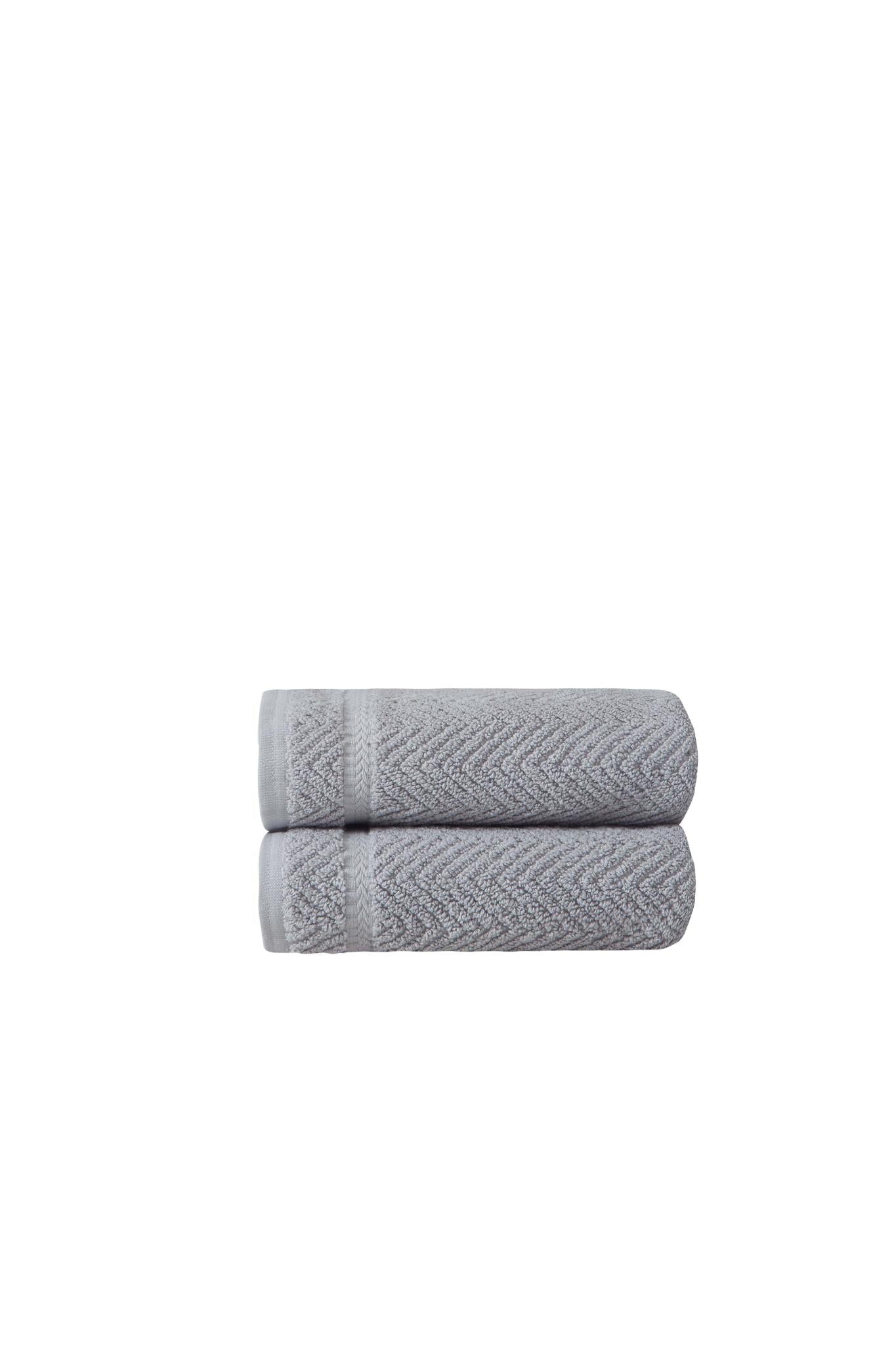 Set of two light gray chevron hand towels, rolled and stacked