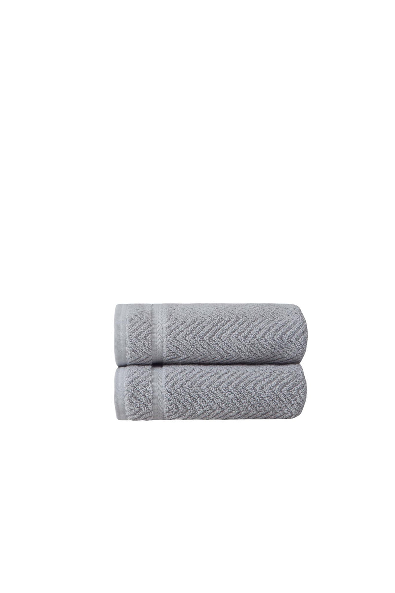 Set of two light gray chevron hand towels, rolled and stacked