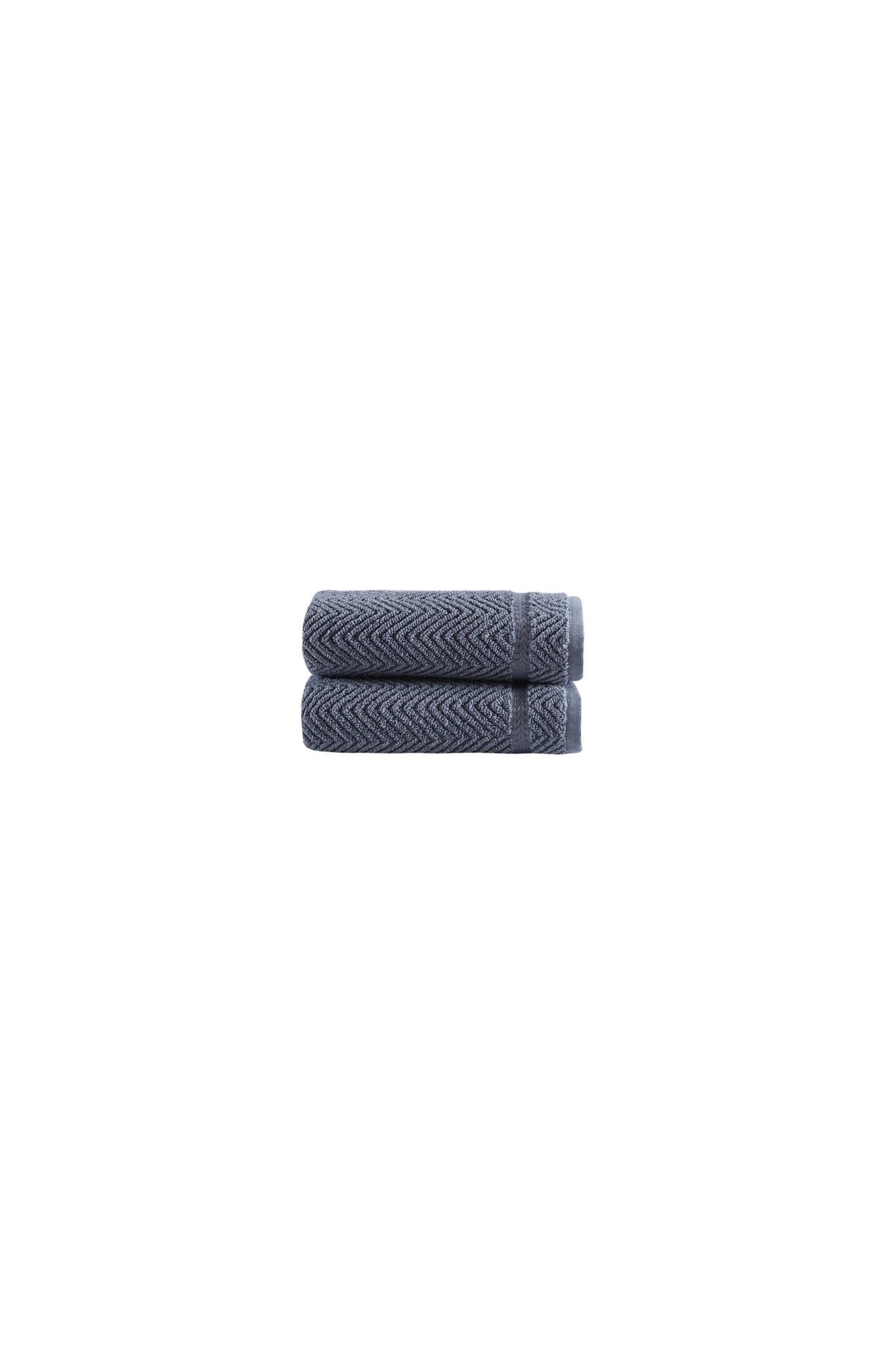 Set of two dark gray chevron hand towels, neatly folded on white background