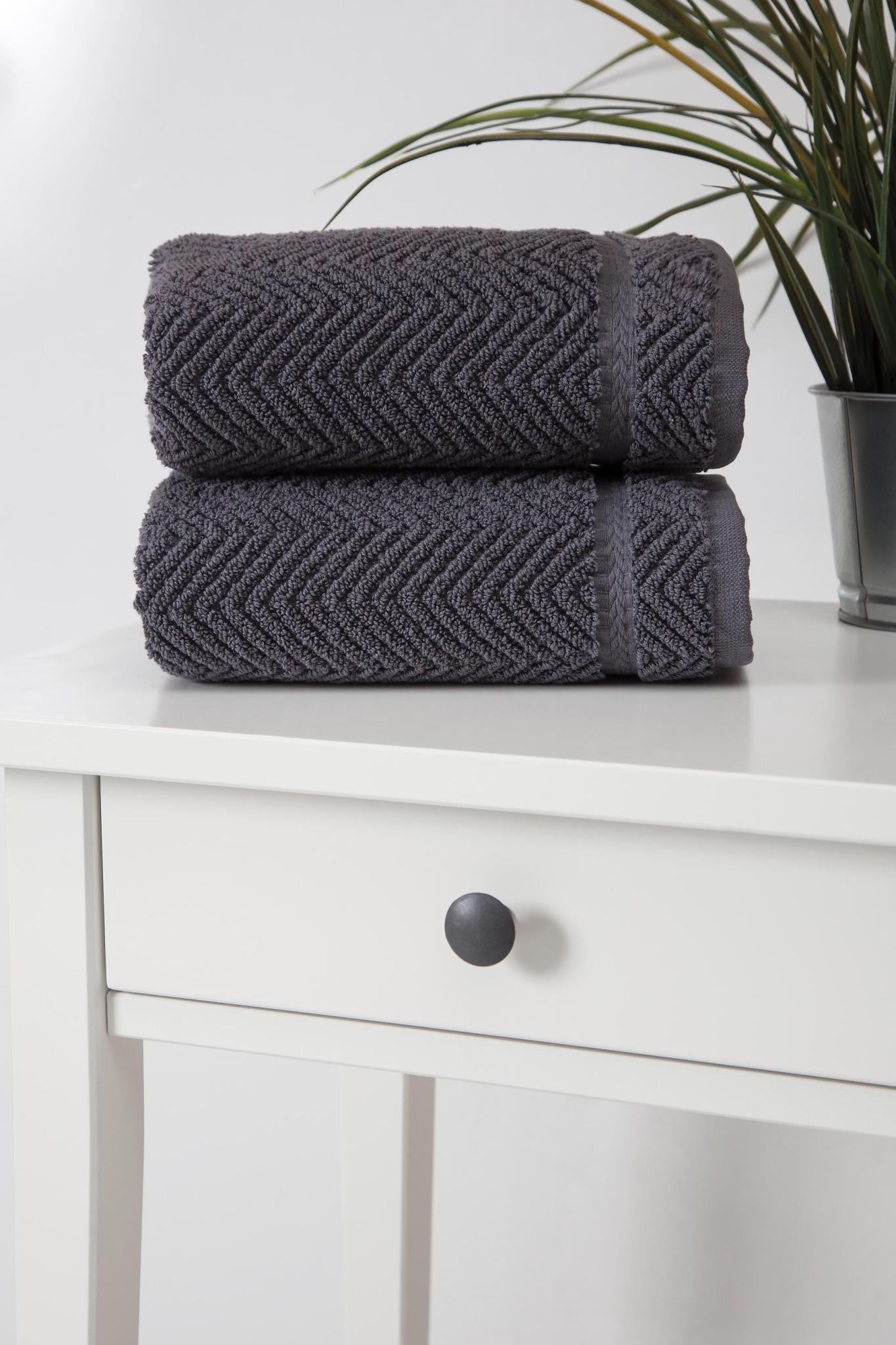 Set of two dark gray chevron Turkish cotton hand towels stacked, corner view
