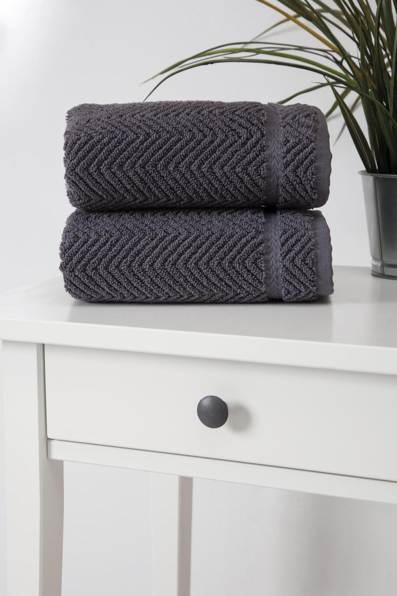 Set of two dark gray chevron Turkish cotton hand towels stacked, corner view