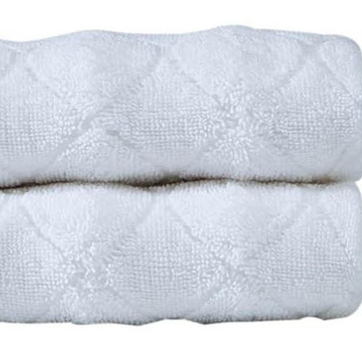 Set of two white Turkish cotton hand towels, textured geometric pattern, folded stack