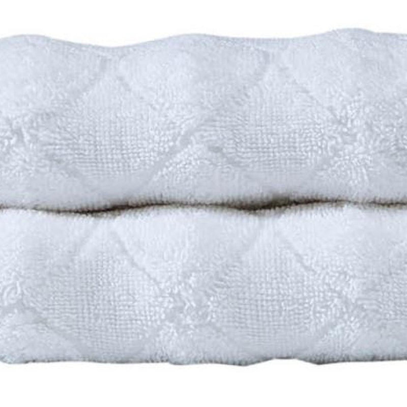 Set of two white Turkish cotton hand towels, folded with raised geometric texture