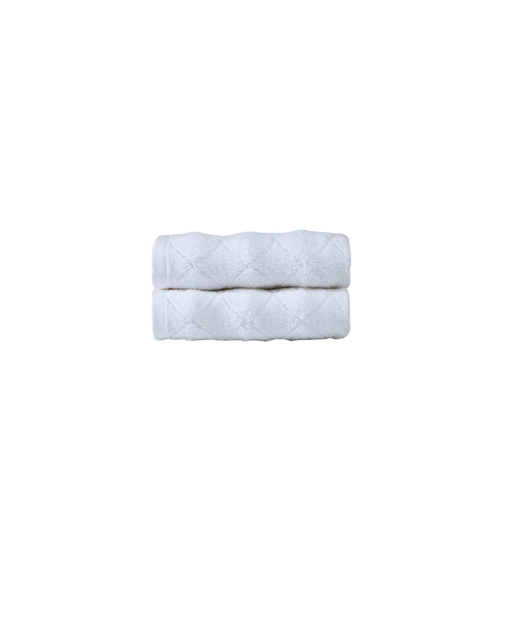 Set of two white Turkish cotton hand towels, neatly folded rectangular stack
