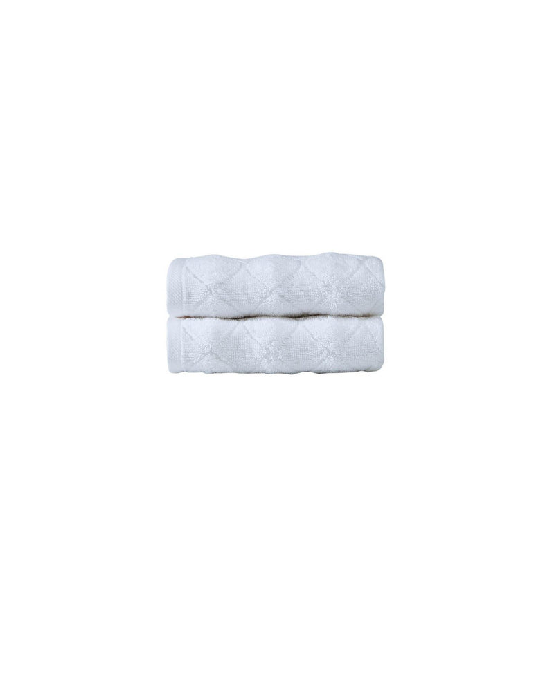 Set of two white Turkish cotton hand towels, neatly folded rectangular stack