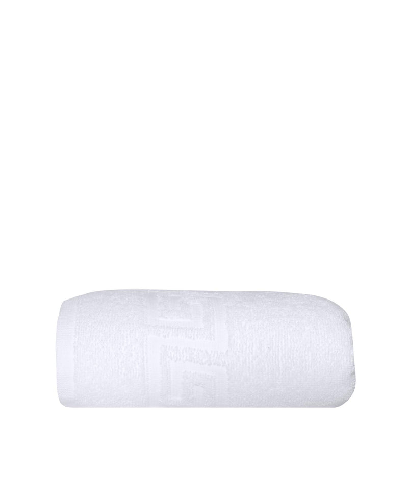 White Turkish cotton hand towel, rolled, with Greek key pattern detail