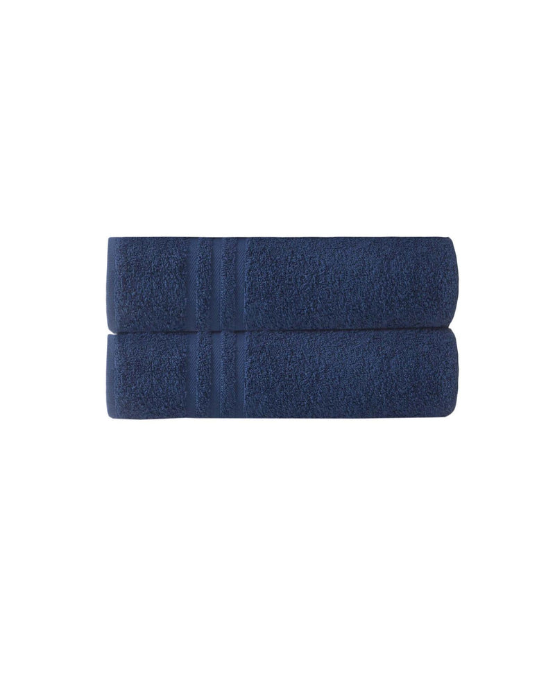 Set of two navy bath towels folded into a neat stack, plush looped texture