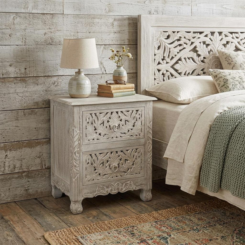 Two-drawer distressed gray wooden nightstand with carved floral front panels.