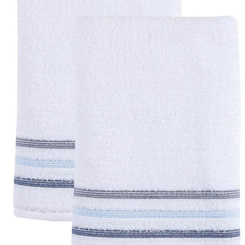 White bath towel close-up with blue striped border along the edge