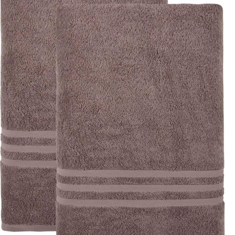 Mauve bath towel close-up, textured terry loops and horizontal striped border
