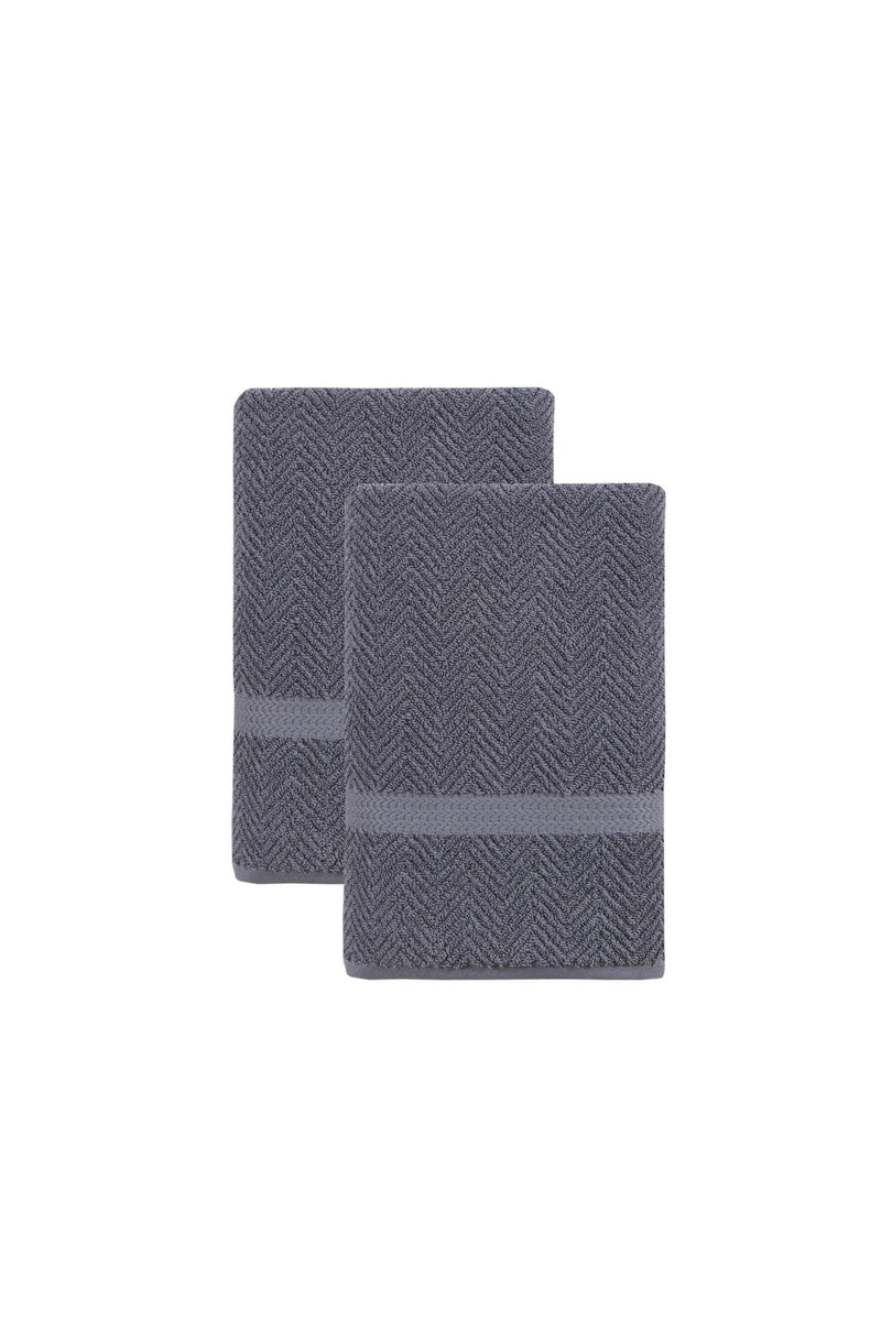 Two light gray chevron bath towels, folded and stacked