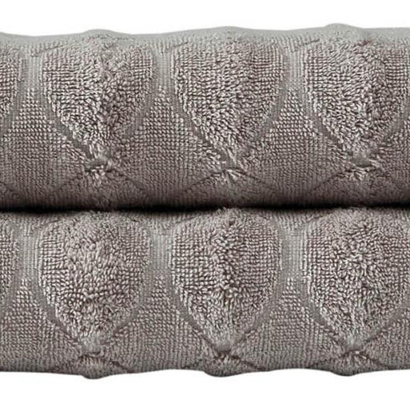 Bath towel detail: light brown Turkish cotton with embossed circular geometric pattern