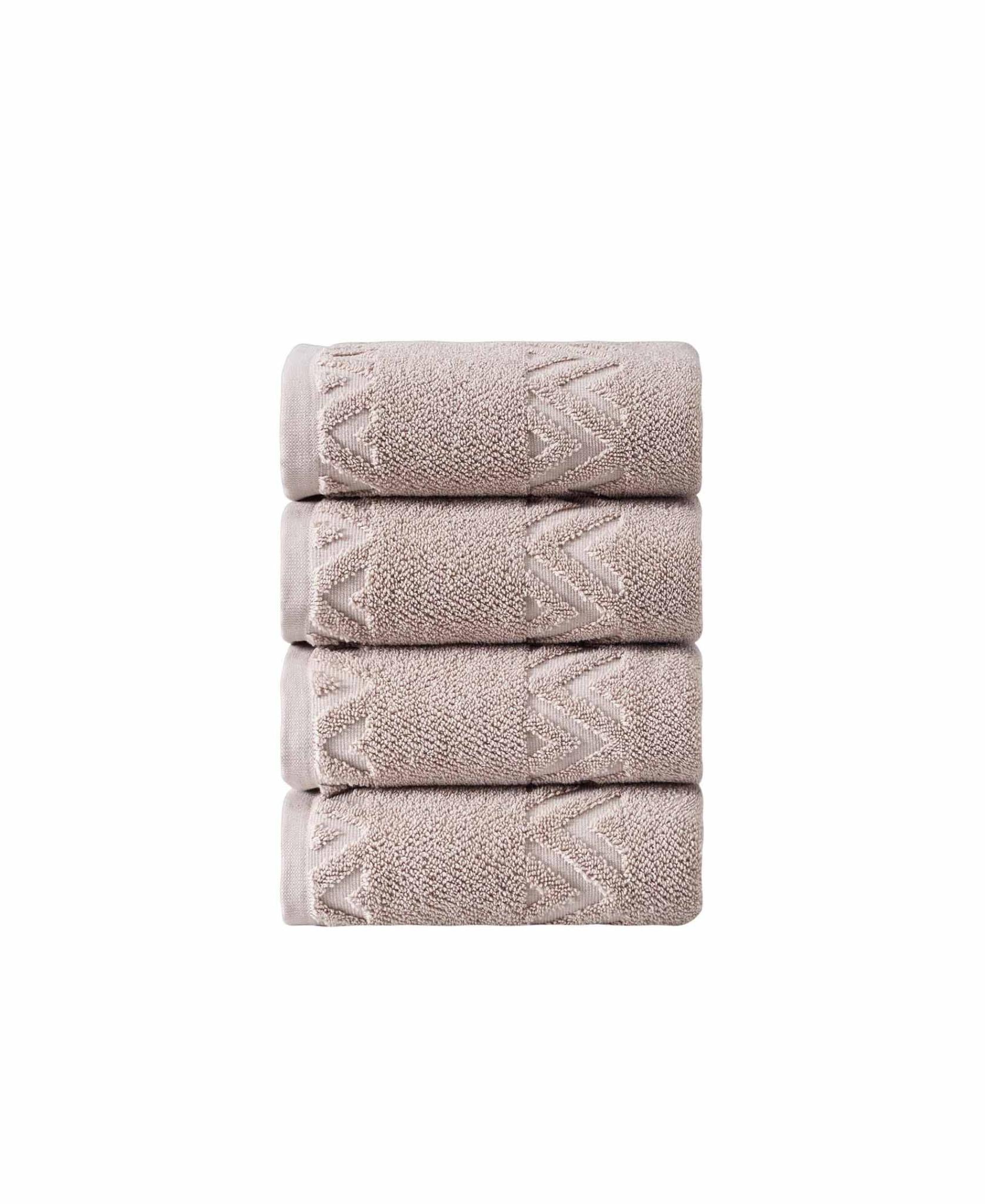 Set of four folded hand towels, light taupe with woven geometric zigzag pattern