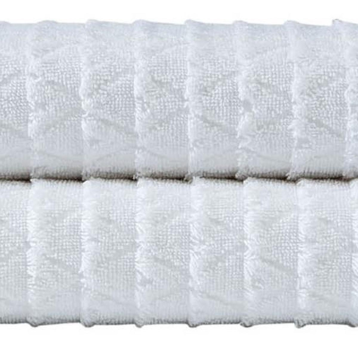 White Turkish cotton bath towel close-up with geometric weave texture and fringe edge