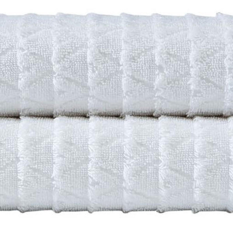White Turkish cotton bath towel close-up with geometric weave texture and fringe edge