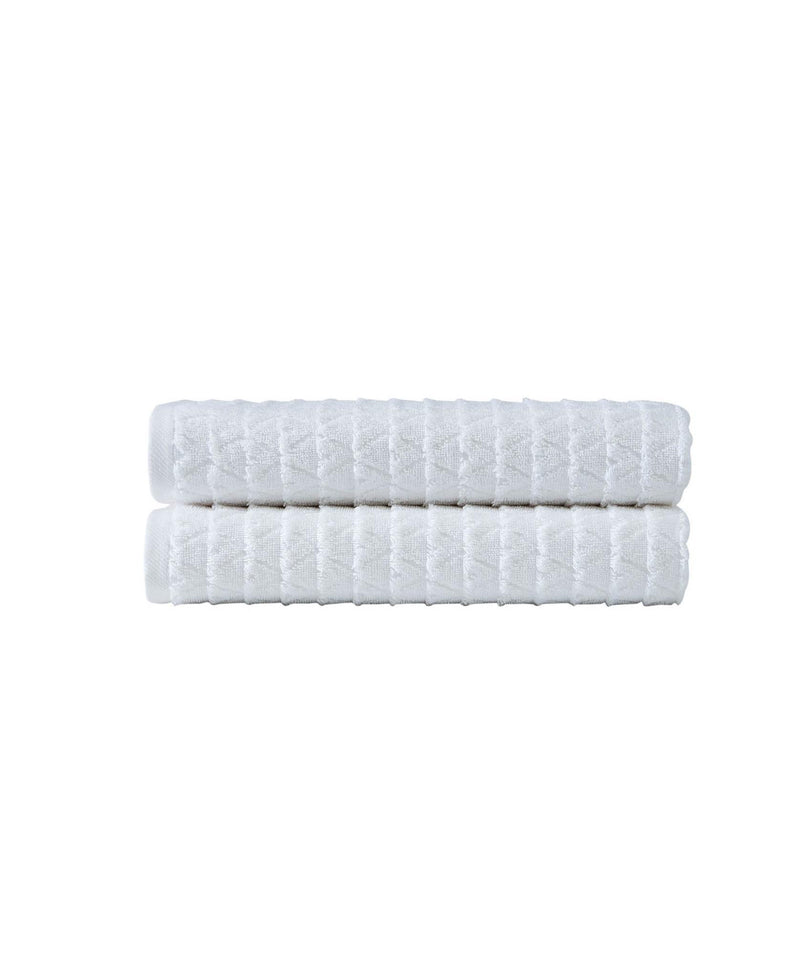 Set of two white bath towels, folded stacks with textured geometric stripe pattern