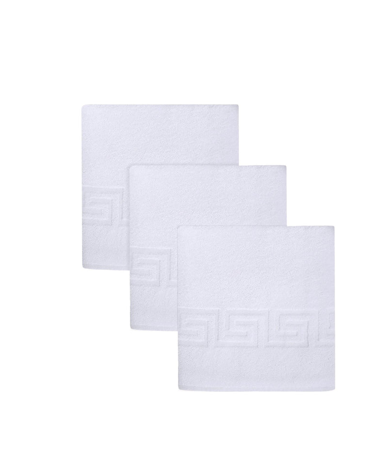 Set of three white Turkish hand towels with Greek key embroidery squares, neatly folded