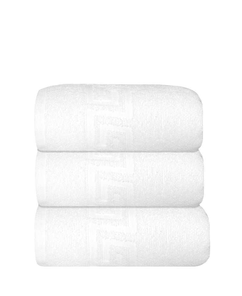 Three white Turkish hand towels stacked, smooth white fabric with Greek key pattern
