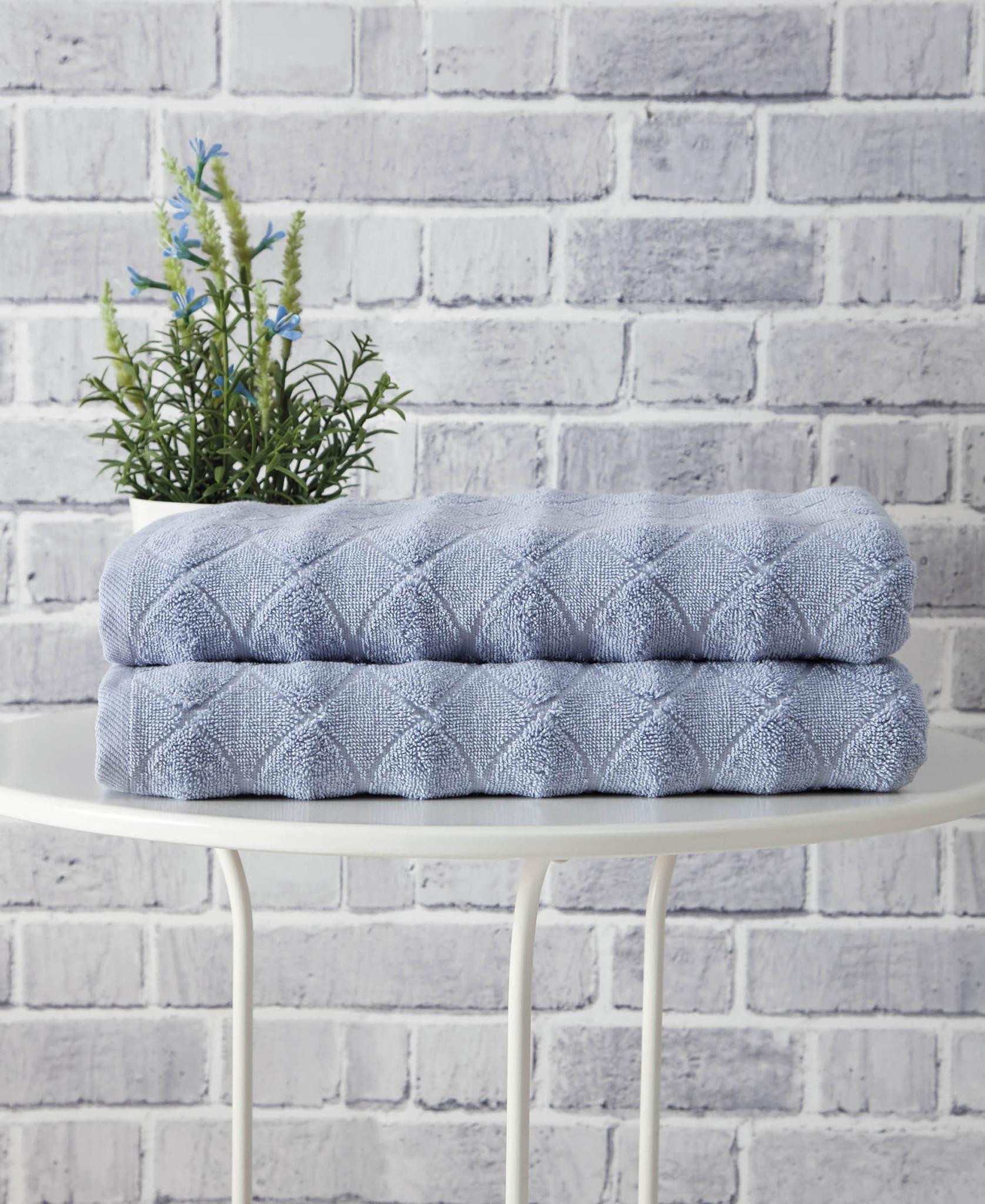 Navy blue geometric Turkish cotton bath towel set, two rolled towels stacked
