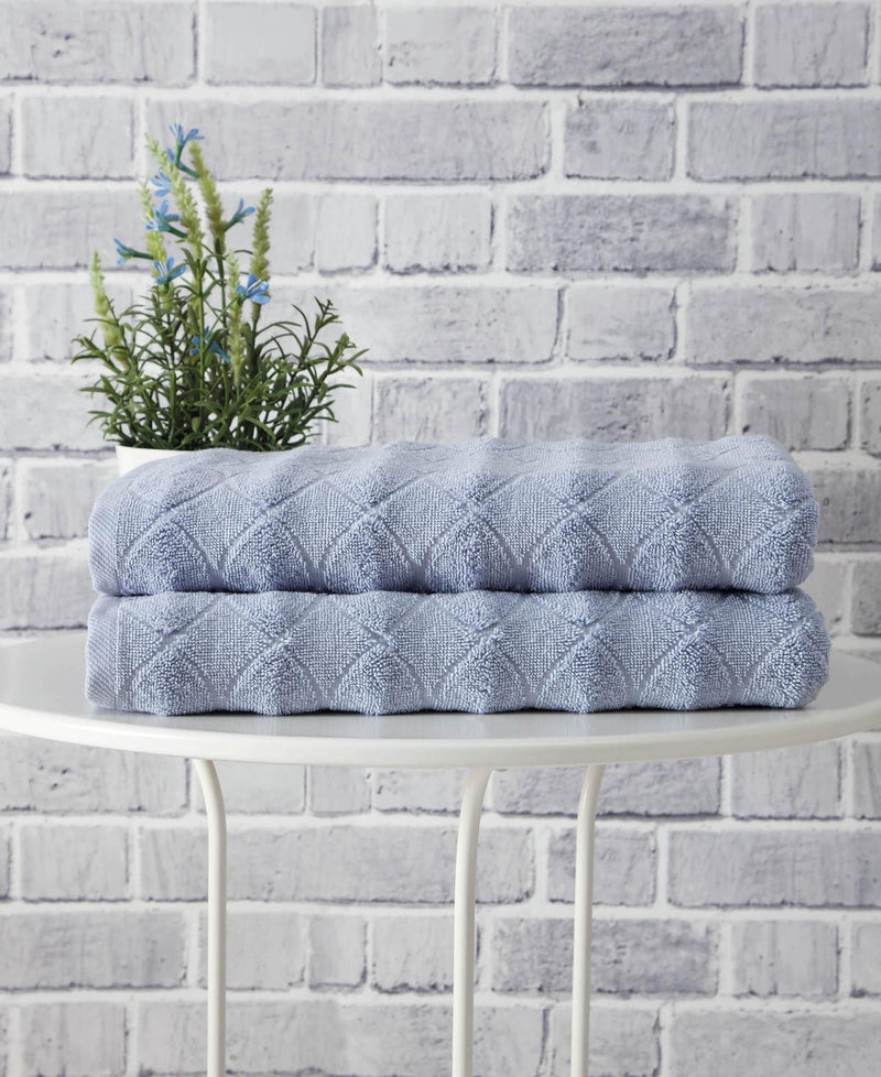 Navy blue geometric Turkish cotton bath towel set, two rolled towels stacked