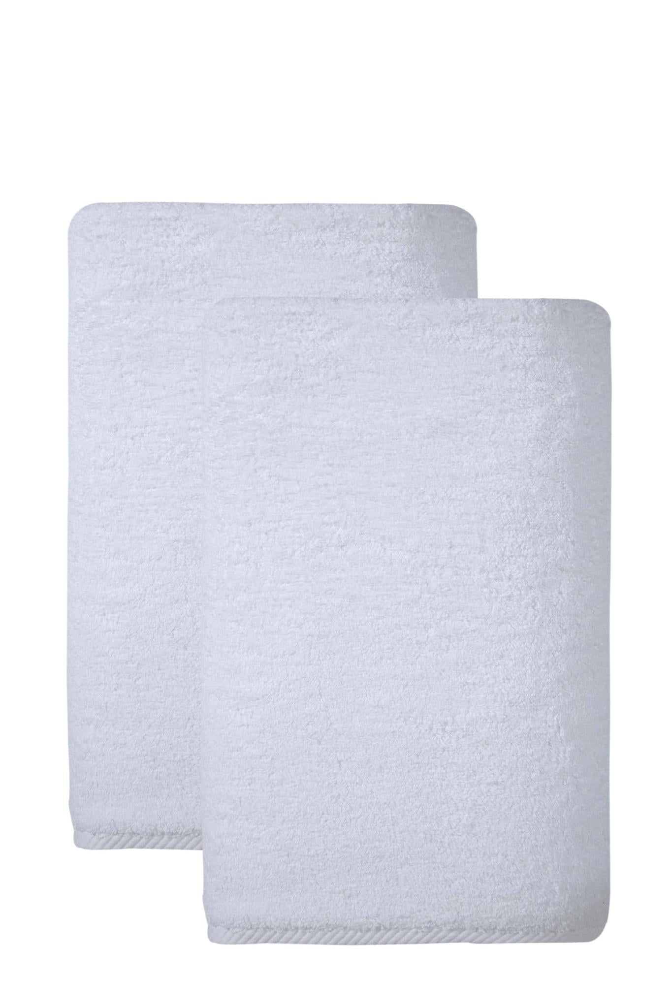 Set of two white bath sheets, neatly folded and stacked