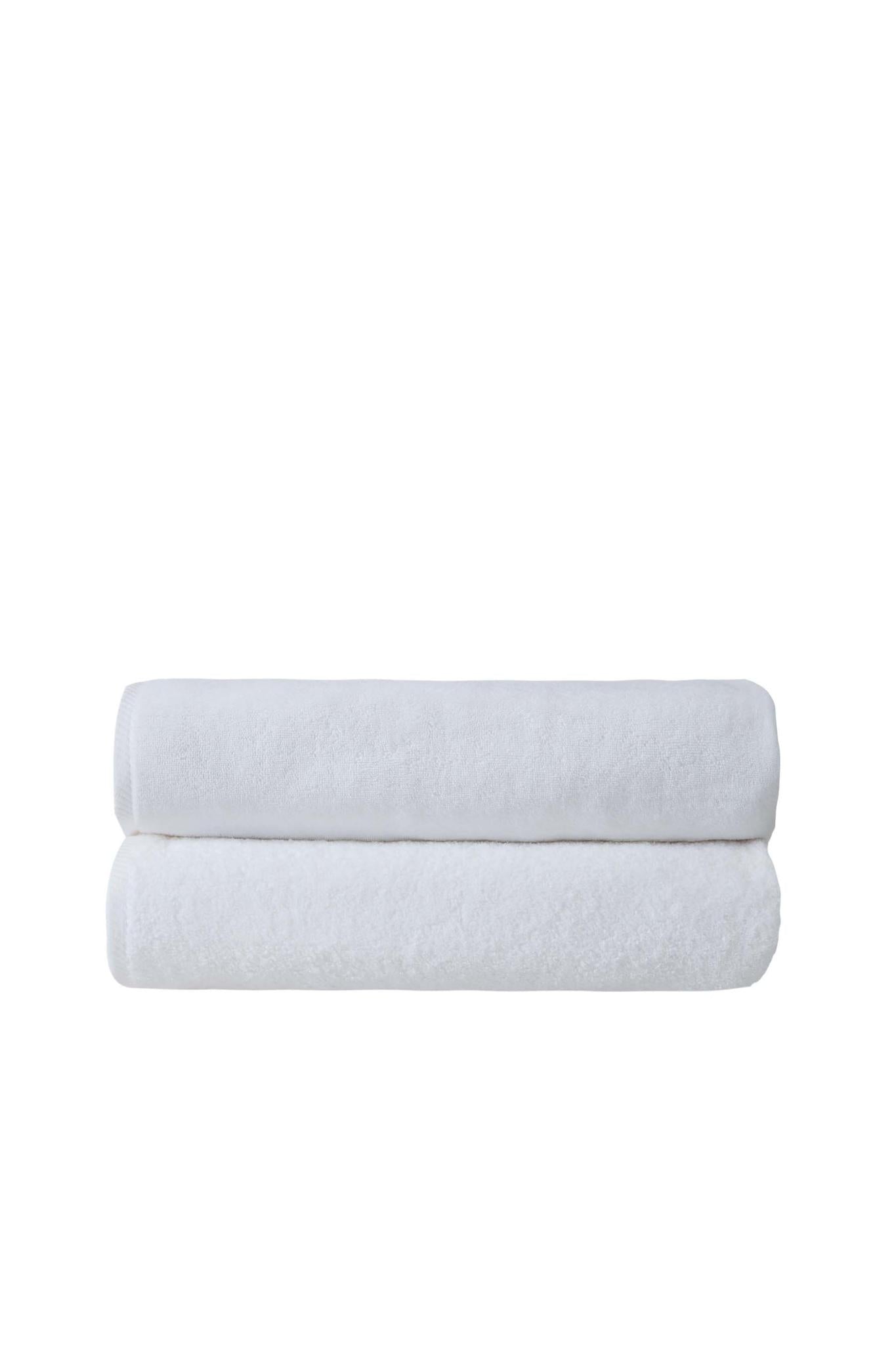 Set of two white bath sheets, rolled and stacked